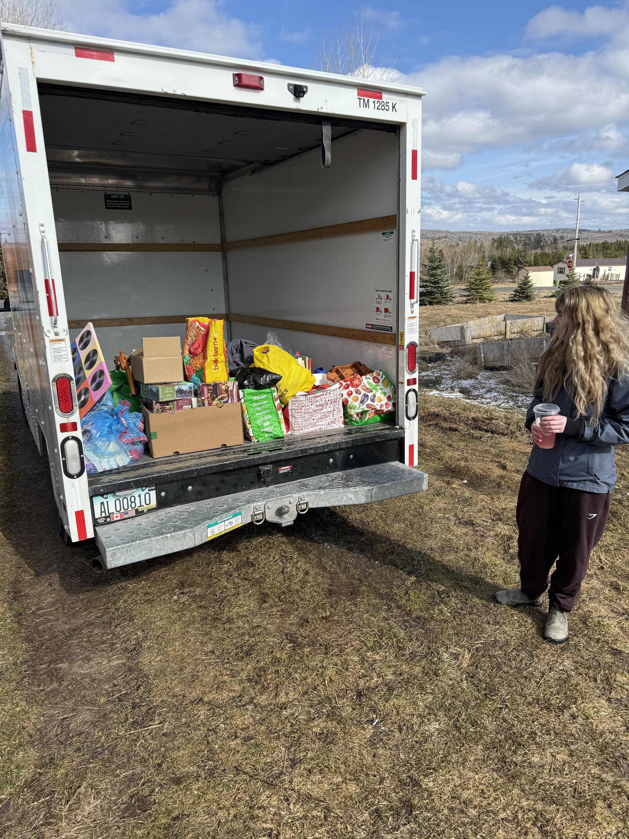 A volunteer beside a truck loaded with donated household goods and clothing for the Value Village FUNDrive